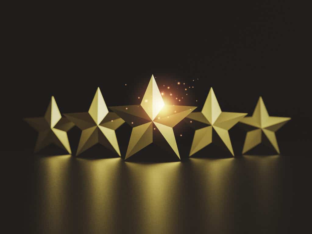 Five gold stars on a black background