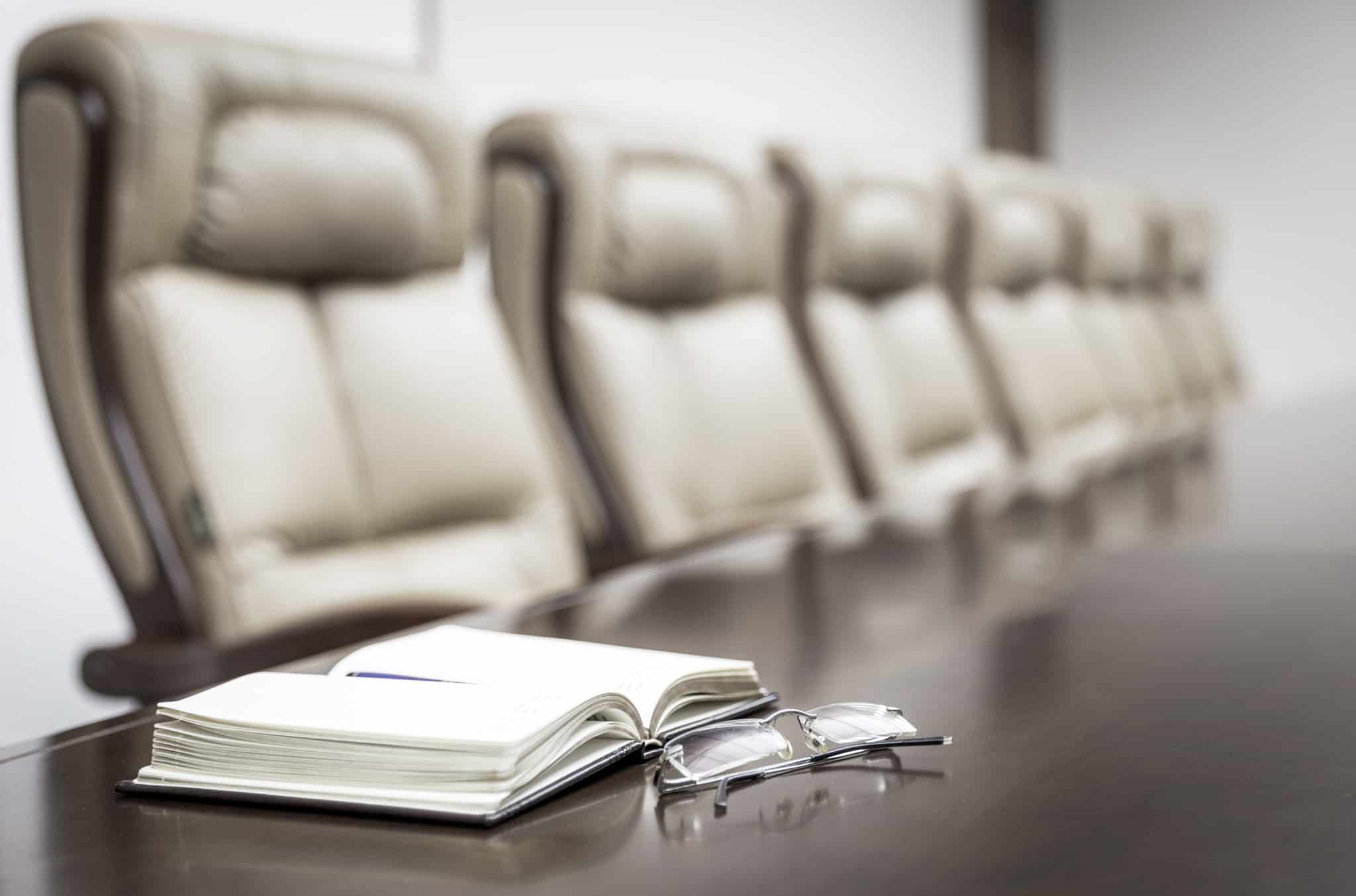 Closeup of a table in empty corporate conference room before business meeting in office